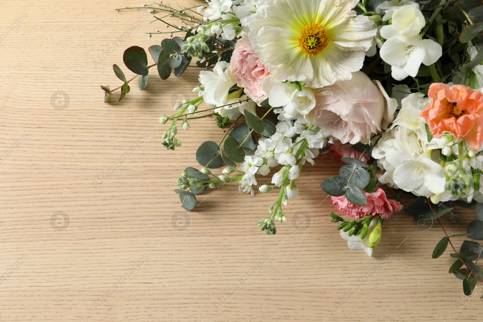 Photo of Bouquet of beautiful flowers on wooden table, closeup with above view. Space for text