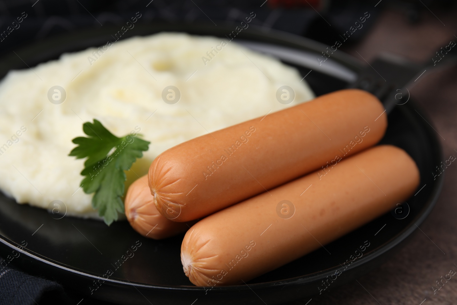 Photo of Delicious boiled sausages, mashed potato and parsley on table, closeup