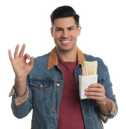 Man with delicious shawarma on white background