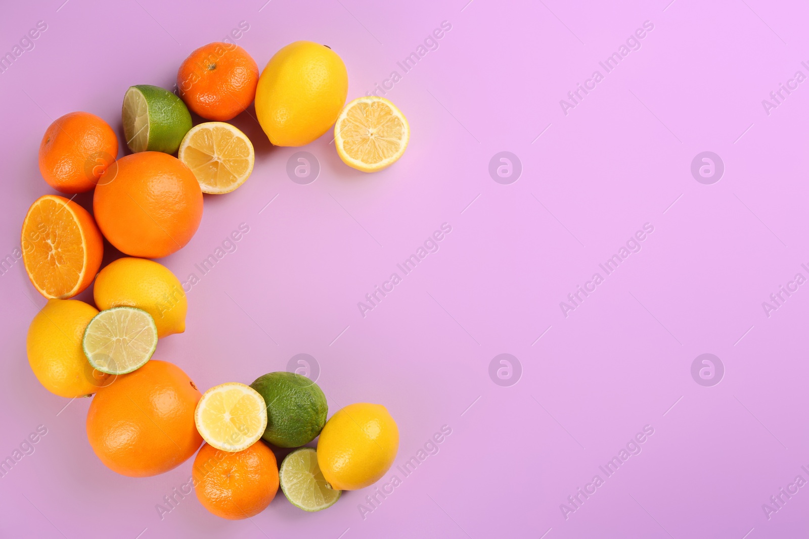 Photo of Letter C made with citrus fruits on lilac background as vitamin representation, flat lay. Space for text
