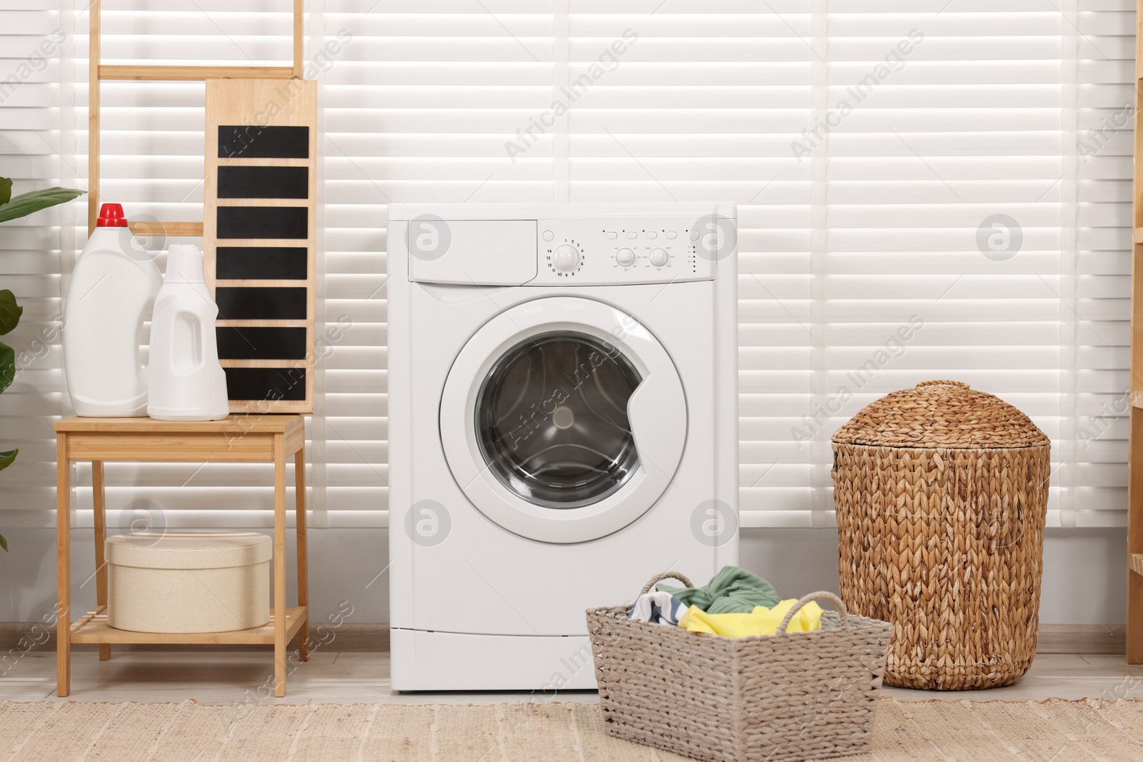 Photo of Laundry room interior with washing machine and baskets