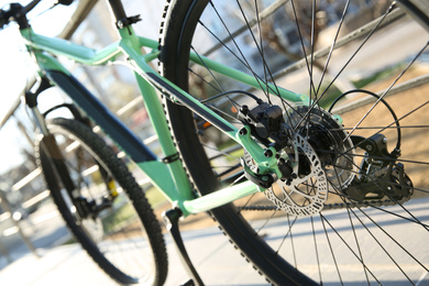 Photo of Modern green bicycle on city street, closeup