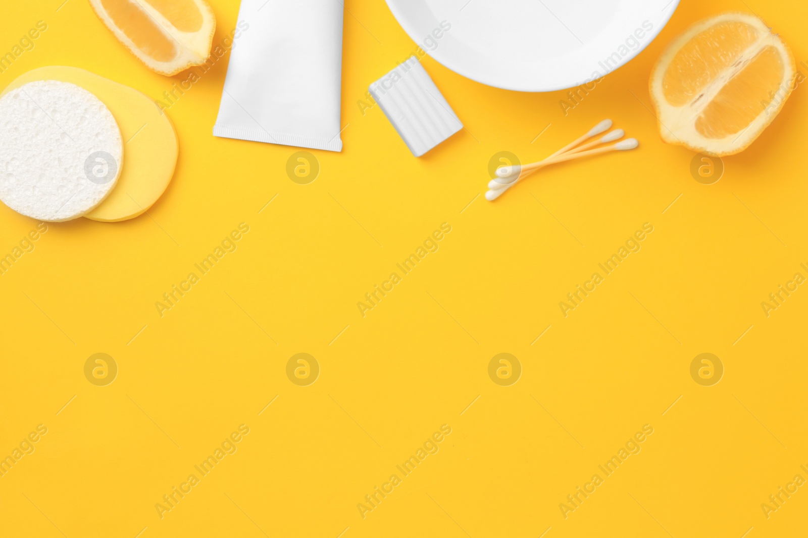 Photo of Lemon face wash. Fresh citrus fruits and personal care products on yellow background, flat lay with space for text