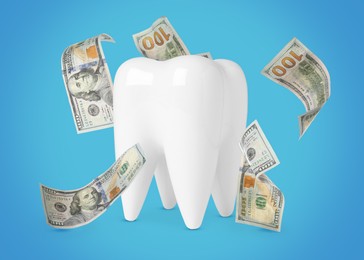 Image of Model of tooth with dollar banknotes on turquoise background. Concept of expensive dental procedures