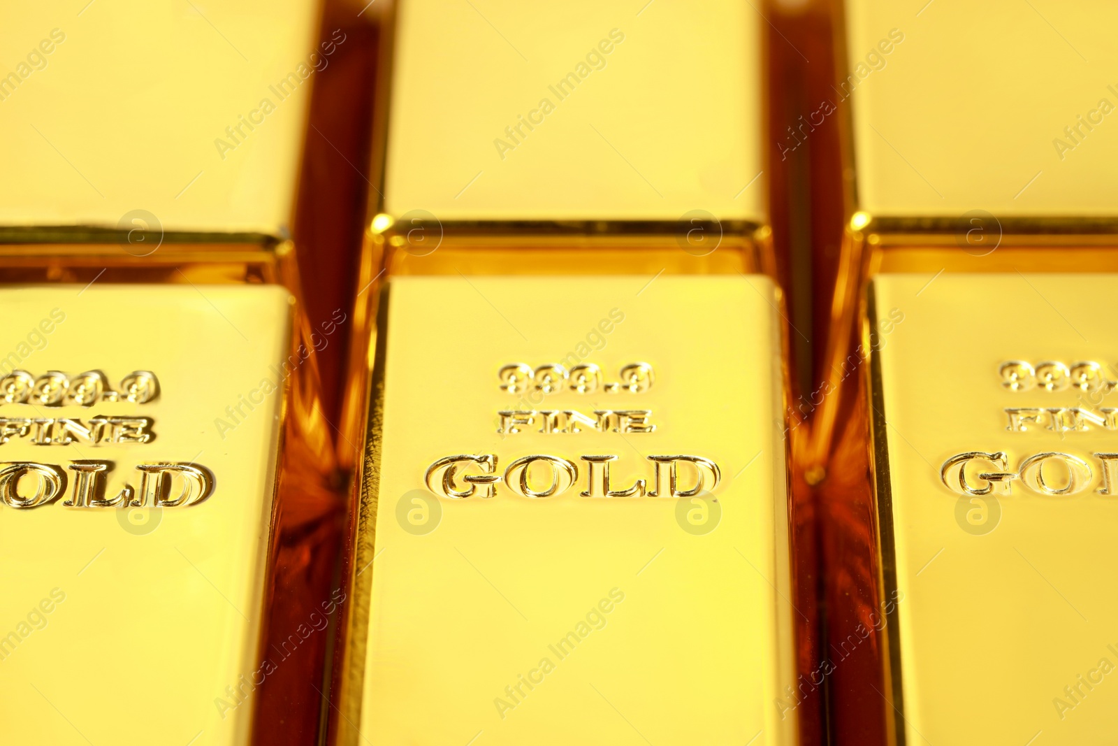 Photo of Many shiny gold bars as background, closeup