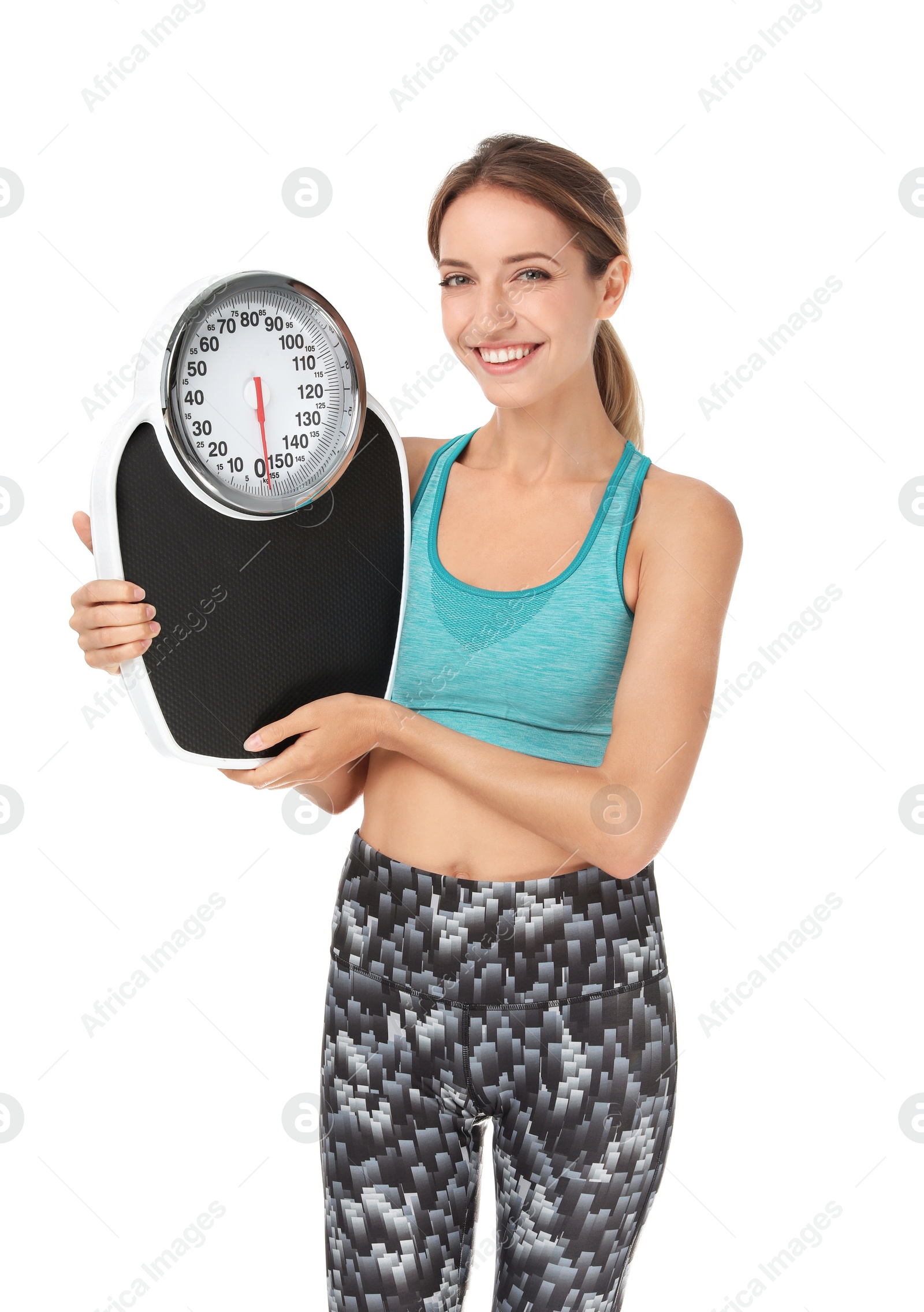 Photo of Happy slim woman satisfied with her diet results holding bathroom scales on white background