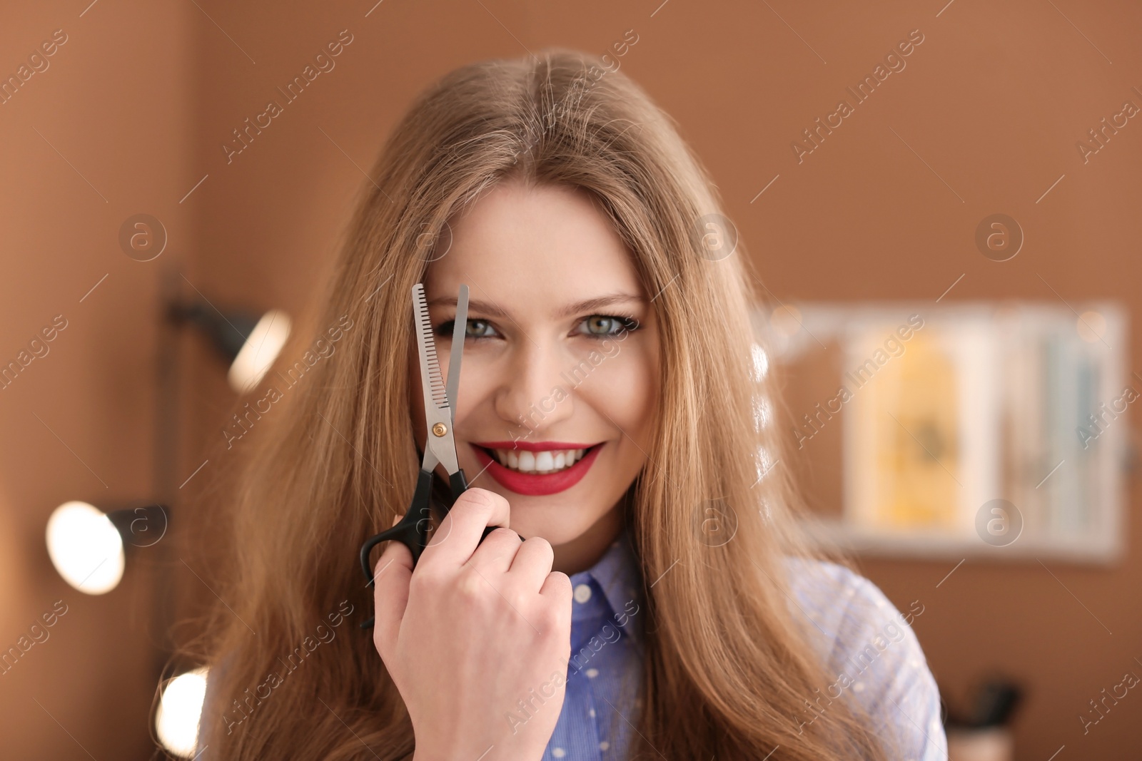 Photo of Professional hairdresser in beauty salon