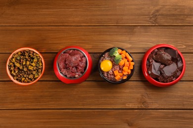 Pet food and natural ingredients on wooden table, flat lay