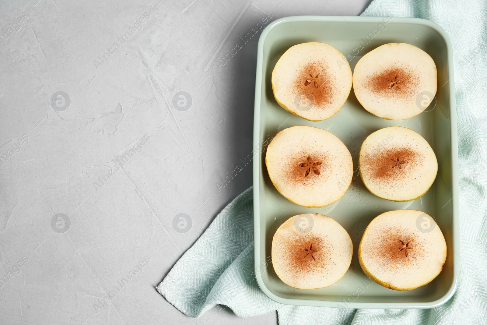 Photo of Flat lay composition with sliced fresh ripe pears, cinnamon and space for text on gray background