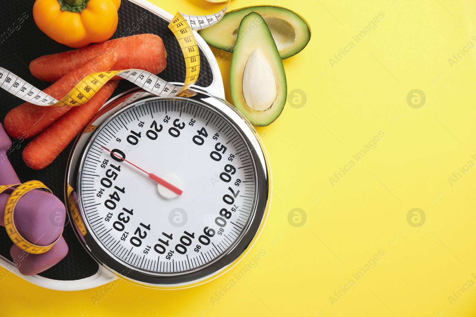 Flat lay composition with scales and vegetables on yellow background, space for text Photo of Flat lay composition with scales and vegetables on yellow background, space for text