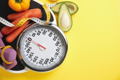 Photo of Flat lay composition with scales and vegetables on yellow background, space for text