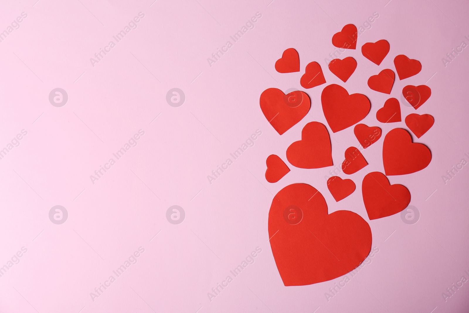 Photo of Paper hearts and space for text on color background, top view