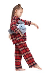 Photo of Girl in pajamas with toy bunny sleepwalking on white background