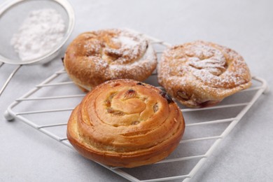 Different delicious rolls on light table, closeup. Sweet buns