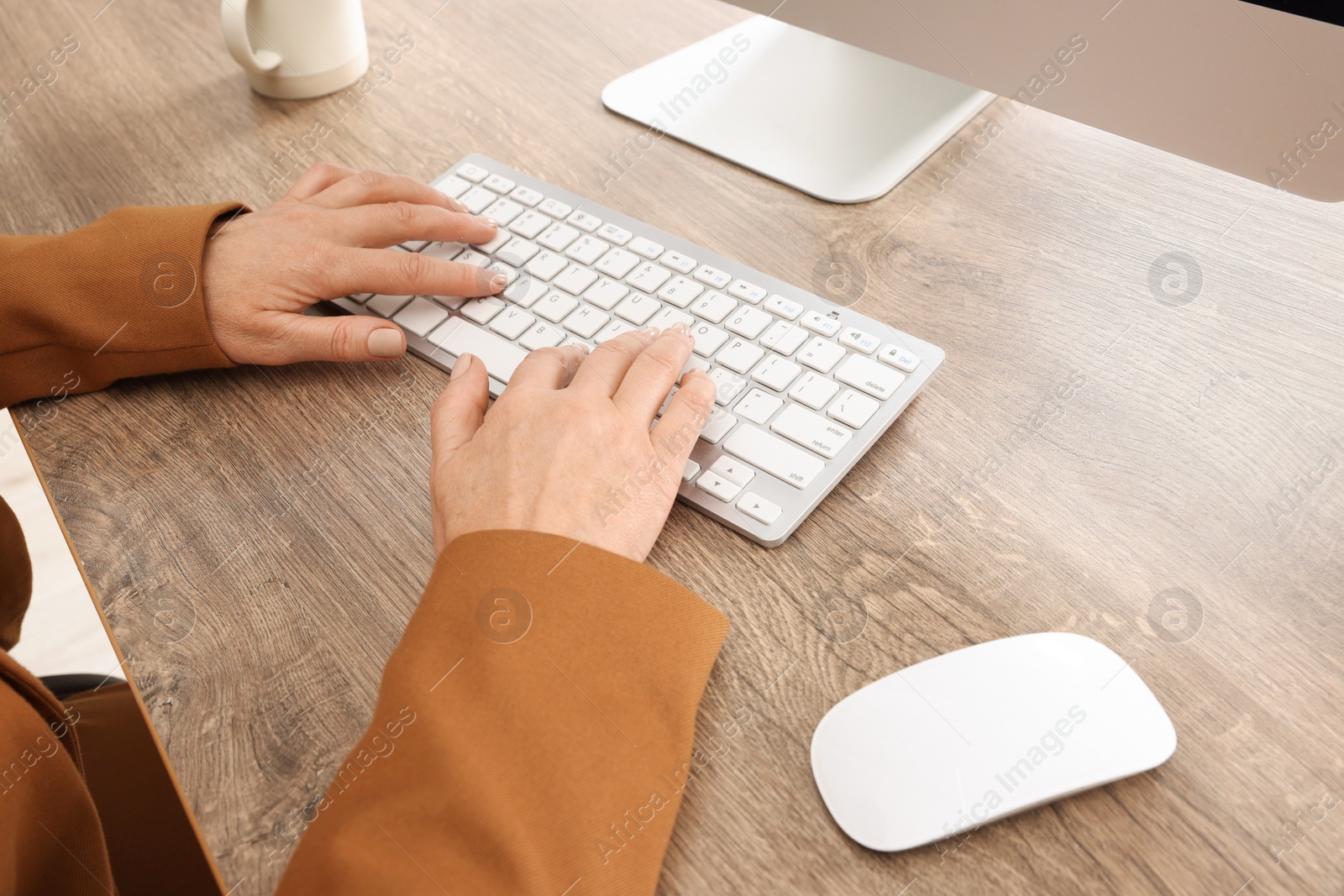 Photo of Lady boss working on computer at desk in office, closeup. Successful businesswoman