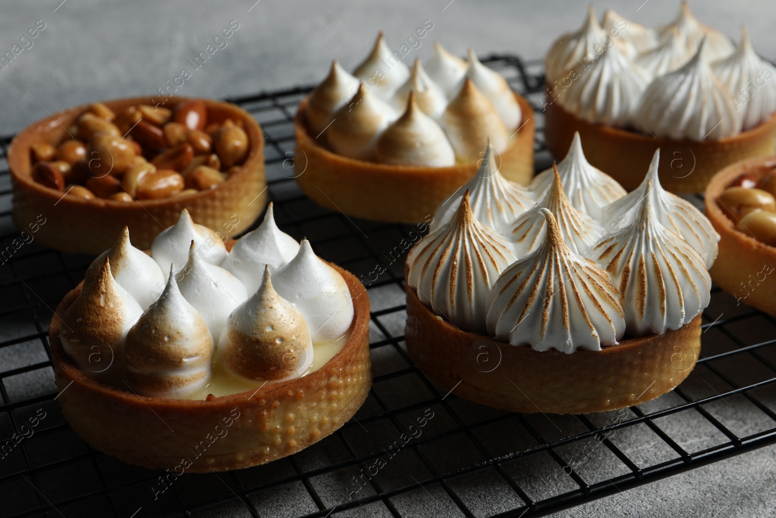 Photo of Many different tartlets on table, closeup. Tasty dessert