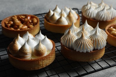 Photo of Many different tartlets on table, closeup. Tasty dessert