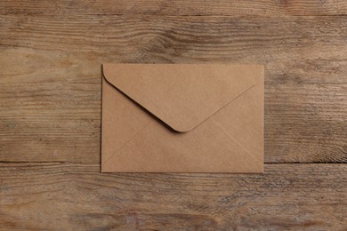 Photo of Paper envelope on wooden table, top view