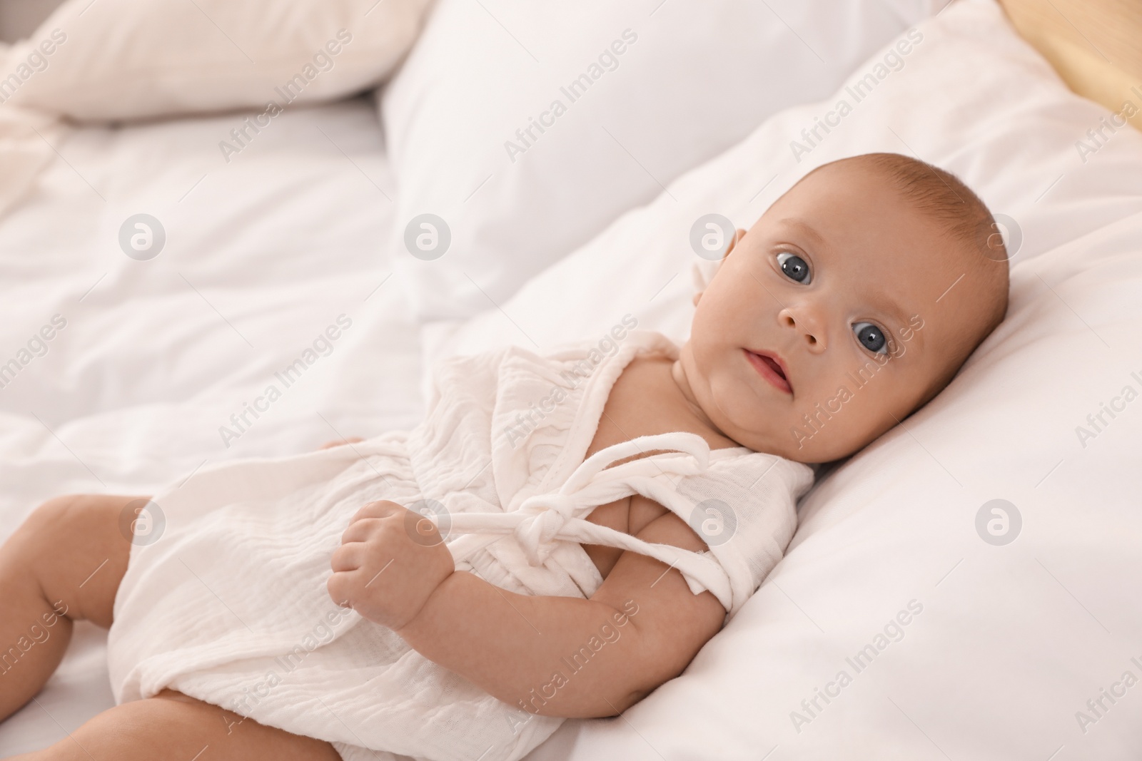 Photo of Cute little baby on bed at home