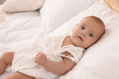 Cute little baby on bed at home