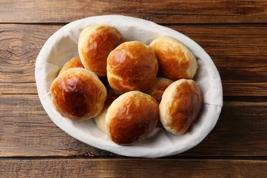 Photo of Tasty scones prepared on soda water on wooden table, top view