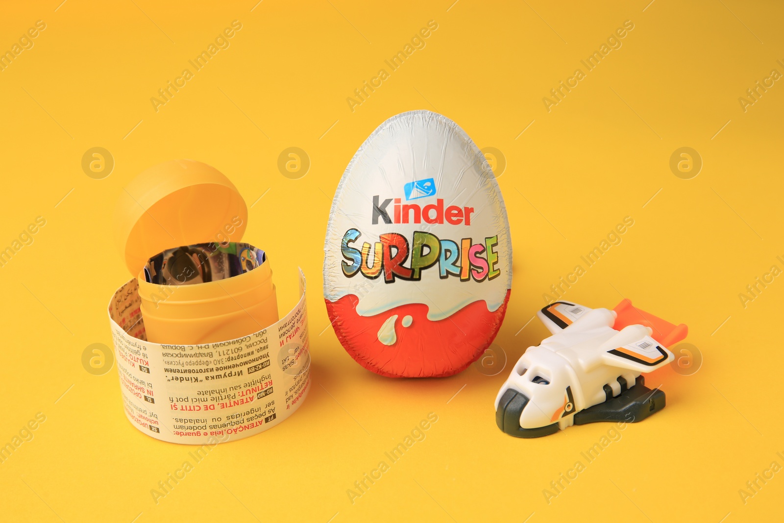 Photo of Sveti Vlas, Bulgaria - June 29, 2023: Kinder Surprise Egg, plastic capsule and toy on orange background