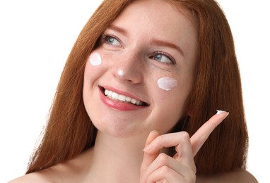 Photo of Smiling woman with freckles and cream on her face against white background, closeup