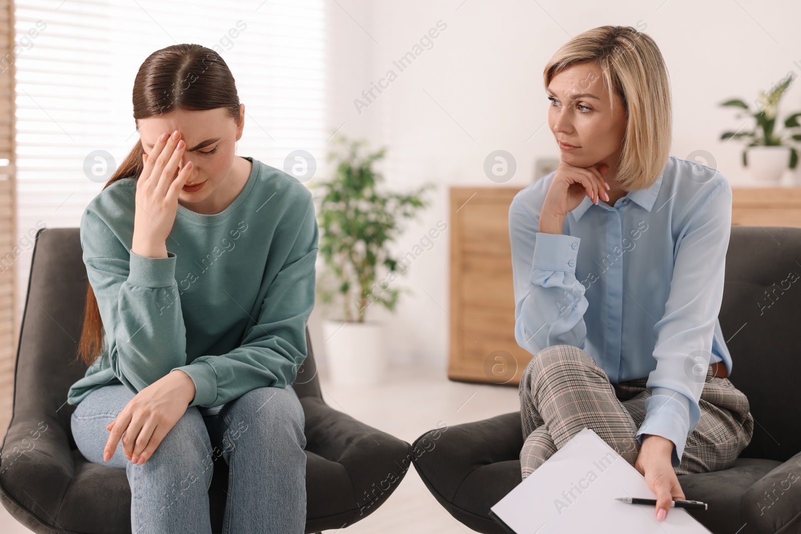 Photo of Professional psychotherapist working with patient in office