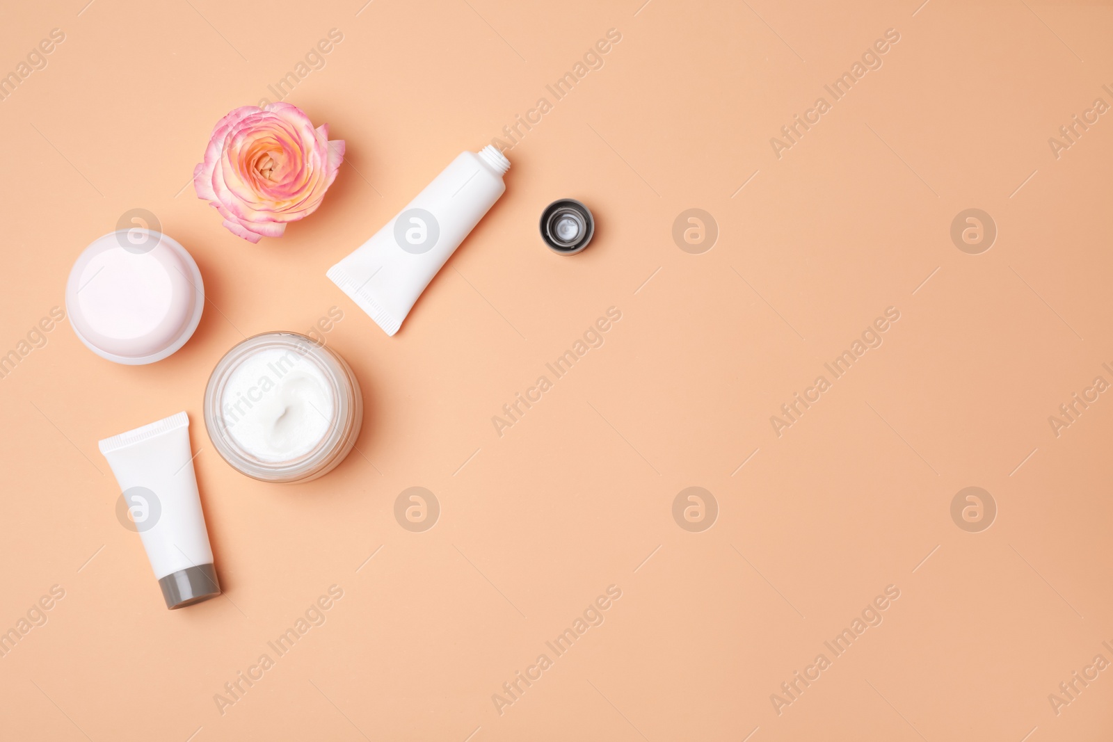 Photo of Flat lay composition with cosmetic products on color background