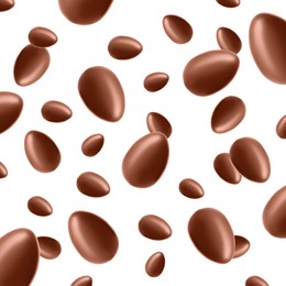 Image of Many chocolate eggs falling on white background