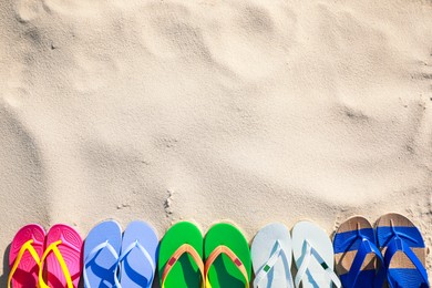 Photo of Stylish flip flops on beach, flat lay. Space for text