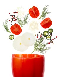 Photo of Fresh ingredients falling into bell pepper on white background. Simple recipe