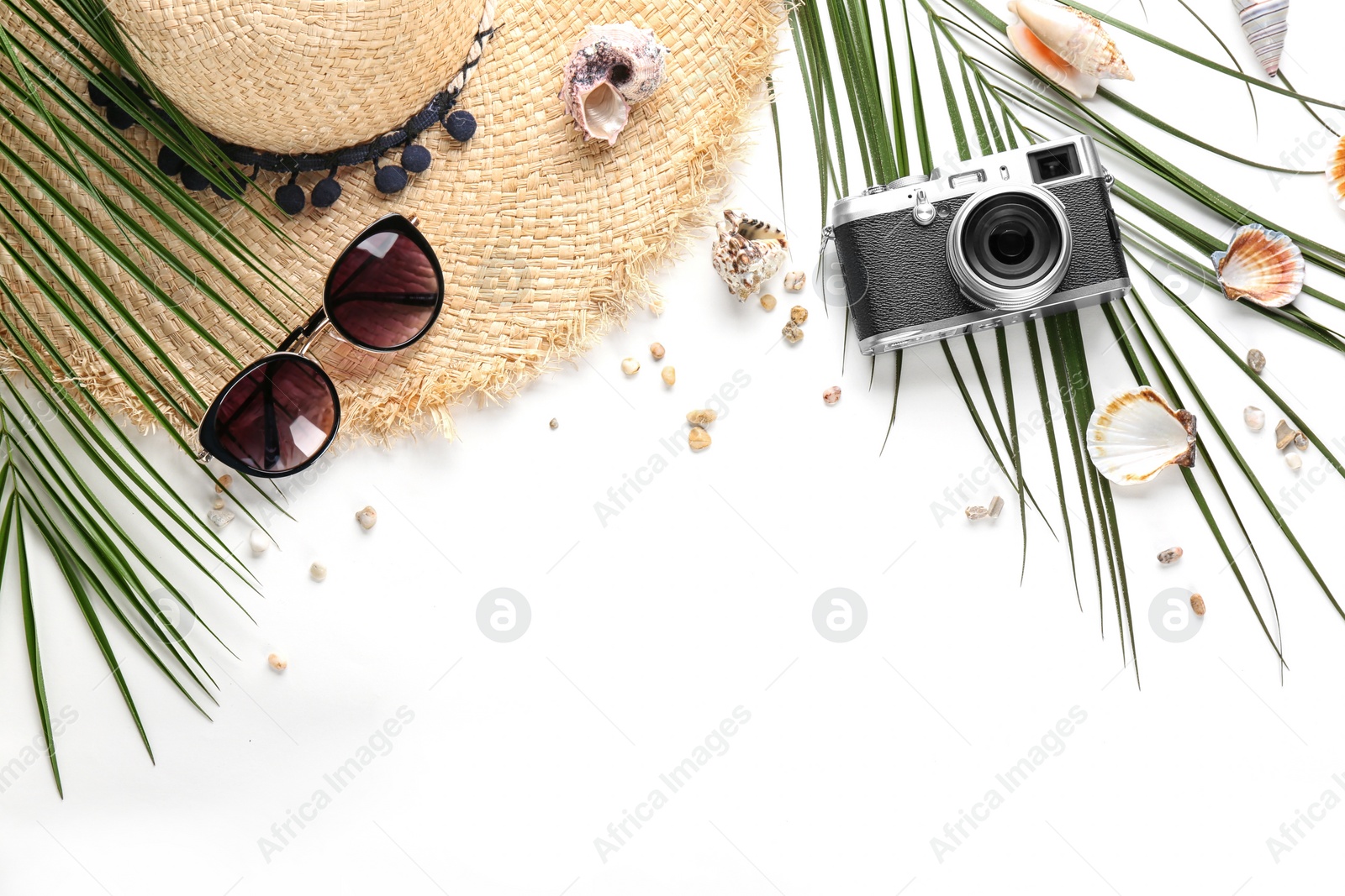 Photo of Flat lay composition with stylish hat, camera and beach objects on white background