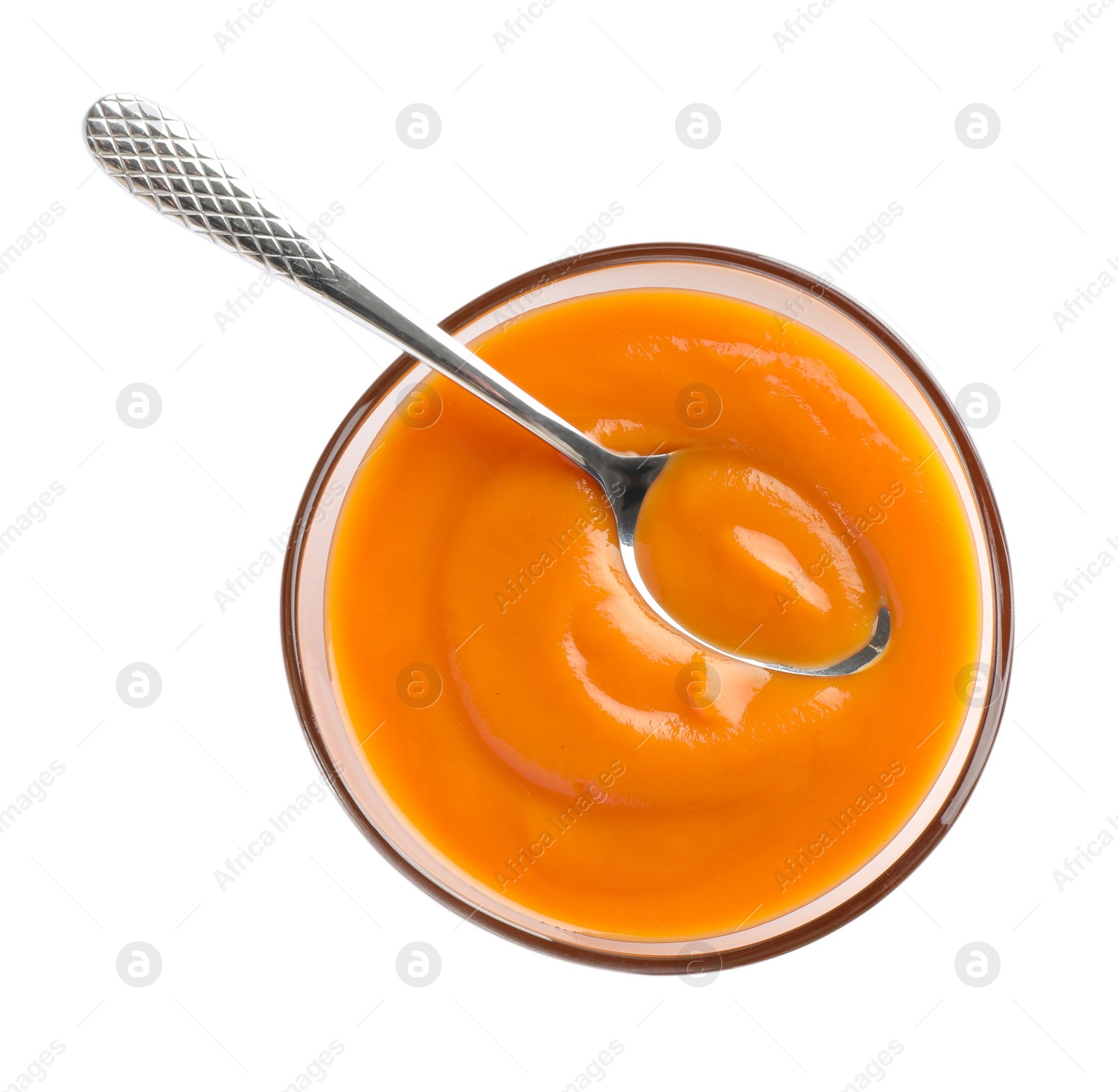 Photo of Delicious persimmon jam and spoon in bowl isolated on white, top view