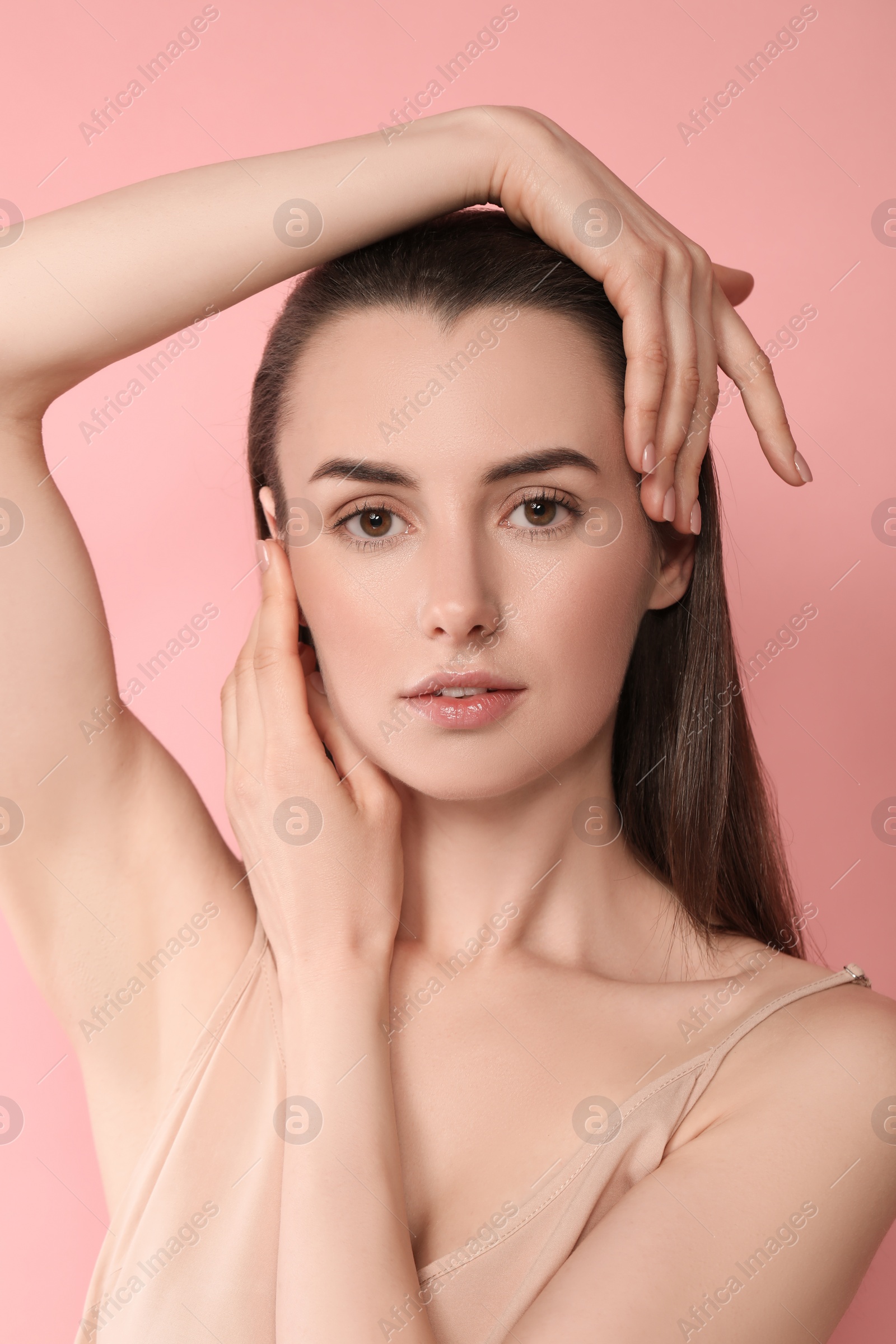 Photo of Portrait of beautiful young woman on pink background