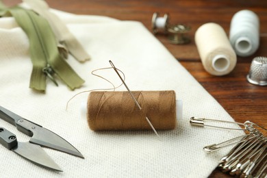 Thread and other sewing supplies on wooden table