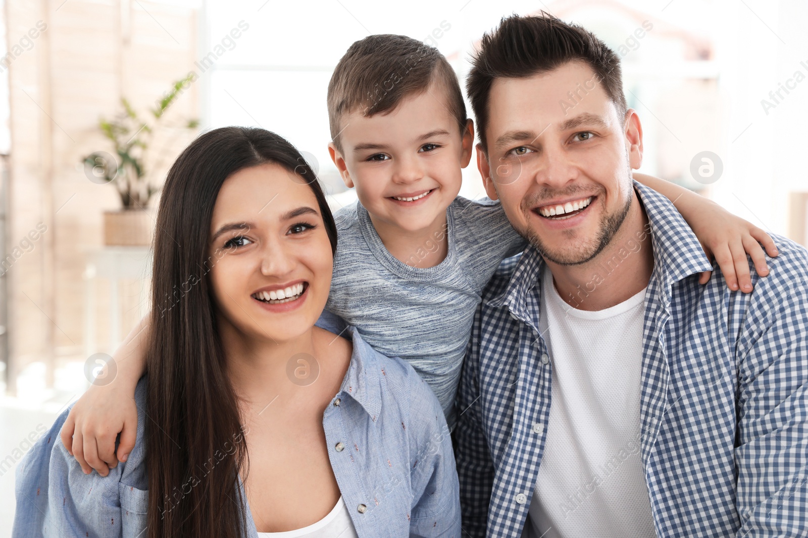 Photo of Happy couple and their son at home. Family time