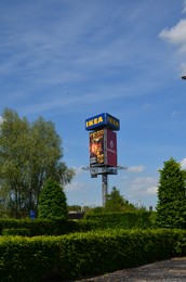 Photo of GRONINGEN, NETHERLANDS - MAY 17, 2022: Stand with advertising posters and IKEA sign in park