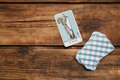 Photo of The Hermit and other tarot cards on wooden table, flat lay. Space for text