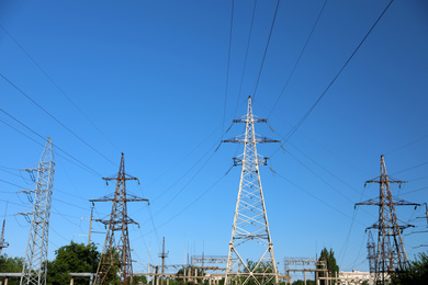 Photo of Modern high voltage towers against blue sky