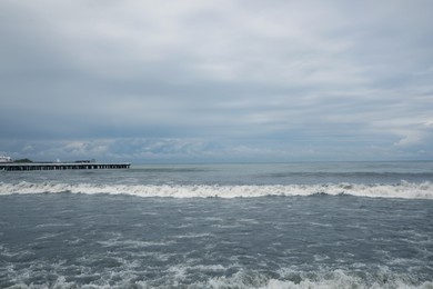 Photo of Picturesque view of sea with waves on cloudy day