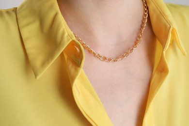 Closeup view of woman wearing metal chain. Luxury jewelry