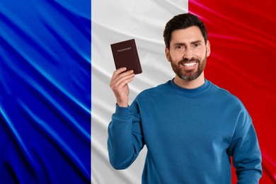Immigration. Happy man with passport against national flag of France, space for text