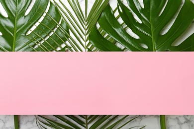 Photo of Flat lay composition with tropical leaves on light background