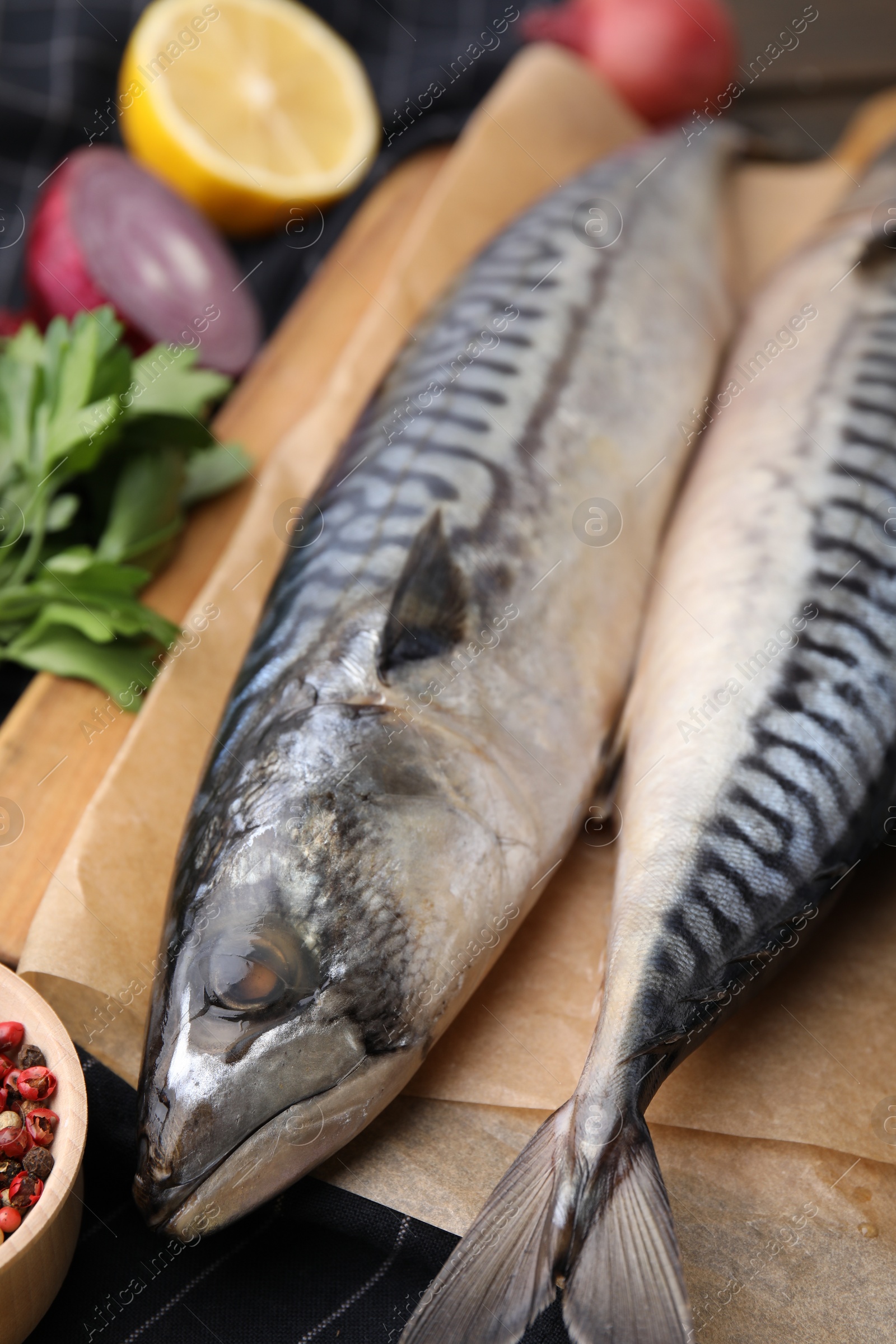 Photo of Tasty salted mackerels on table, closeup view