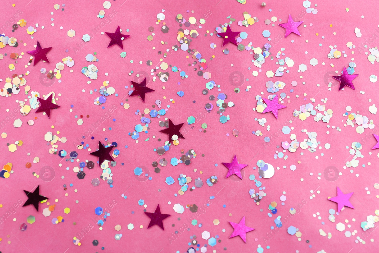 Photo of Shiny glitter on pink background, flat lay