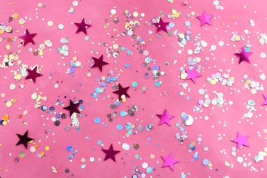 Photo of Shiny glitter on pink background, flat lay