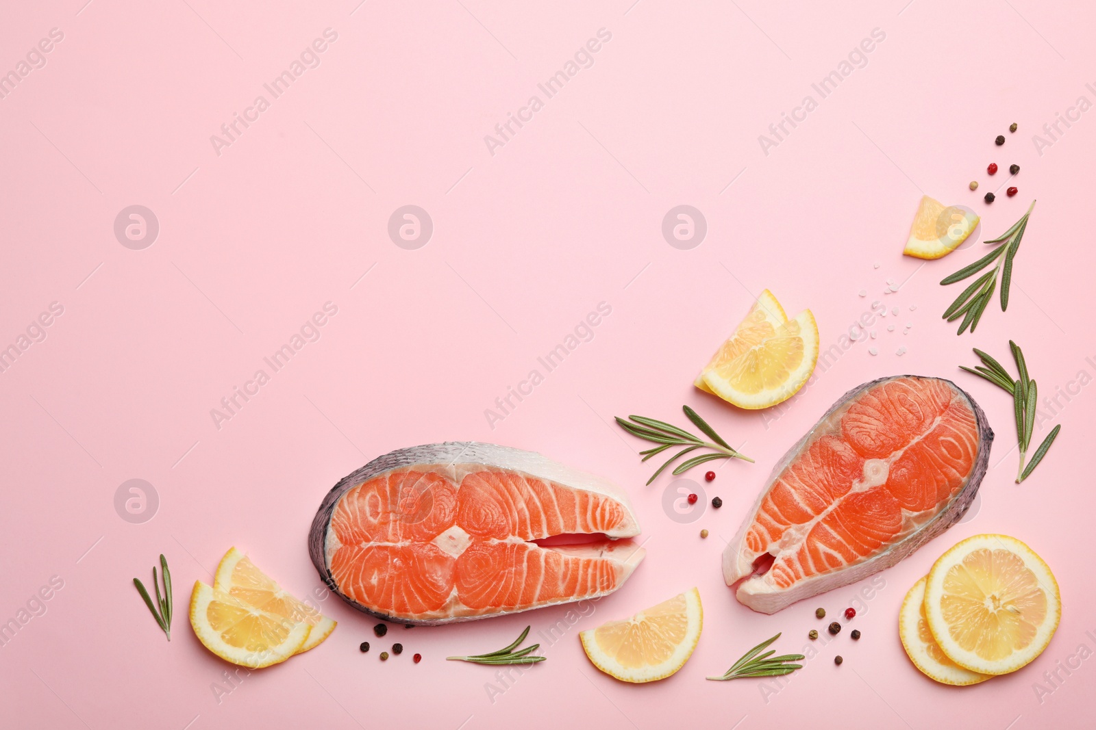 Photo of Flat lay composition with salmon steaks on pink background. Space for text