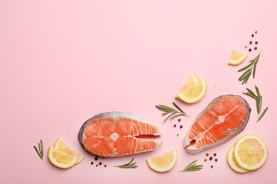 Photo of Flat lay composition with salmon steaks on pink background. Space for text