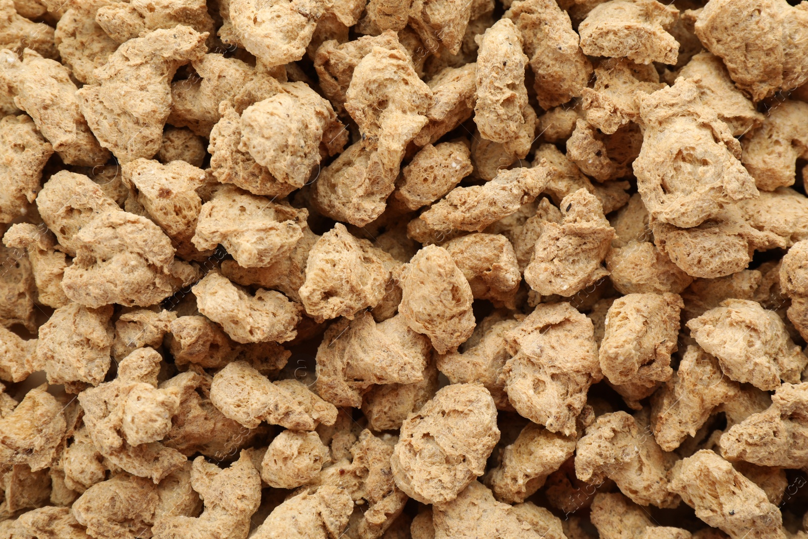 Photo of Dehydrated soy meat chunks as background, top view